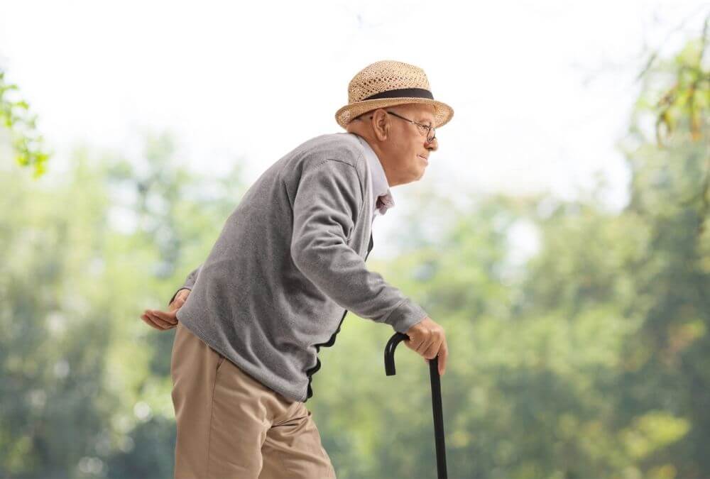 An old man with compressed disc; look like shorter in height